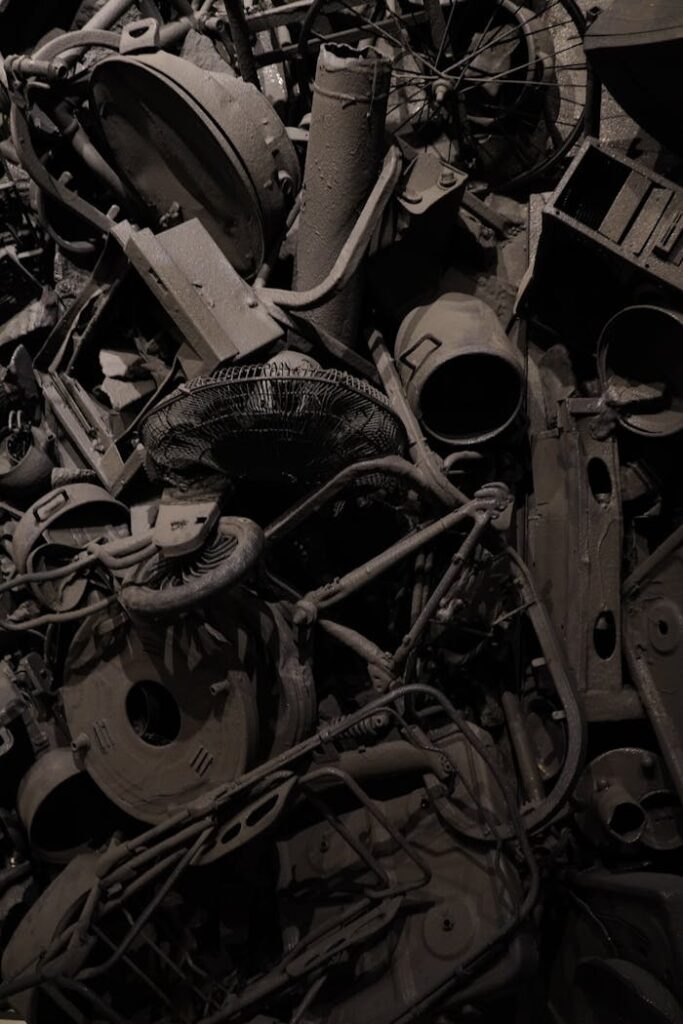 Rusty collection of vintage mechanical junk in dark, moody lighting.